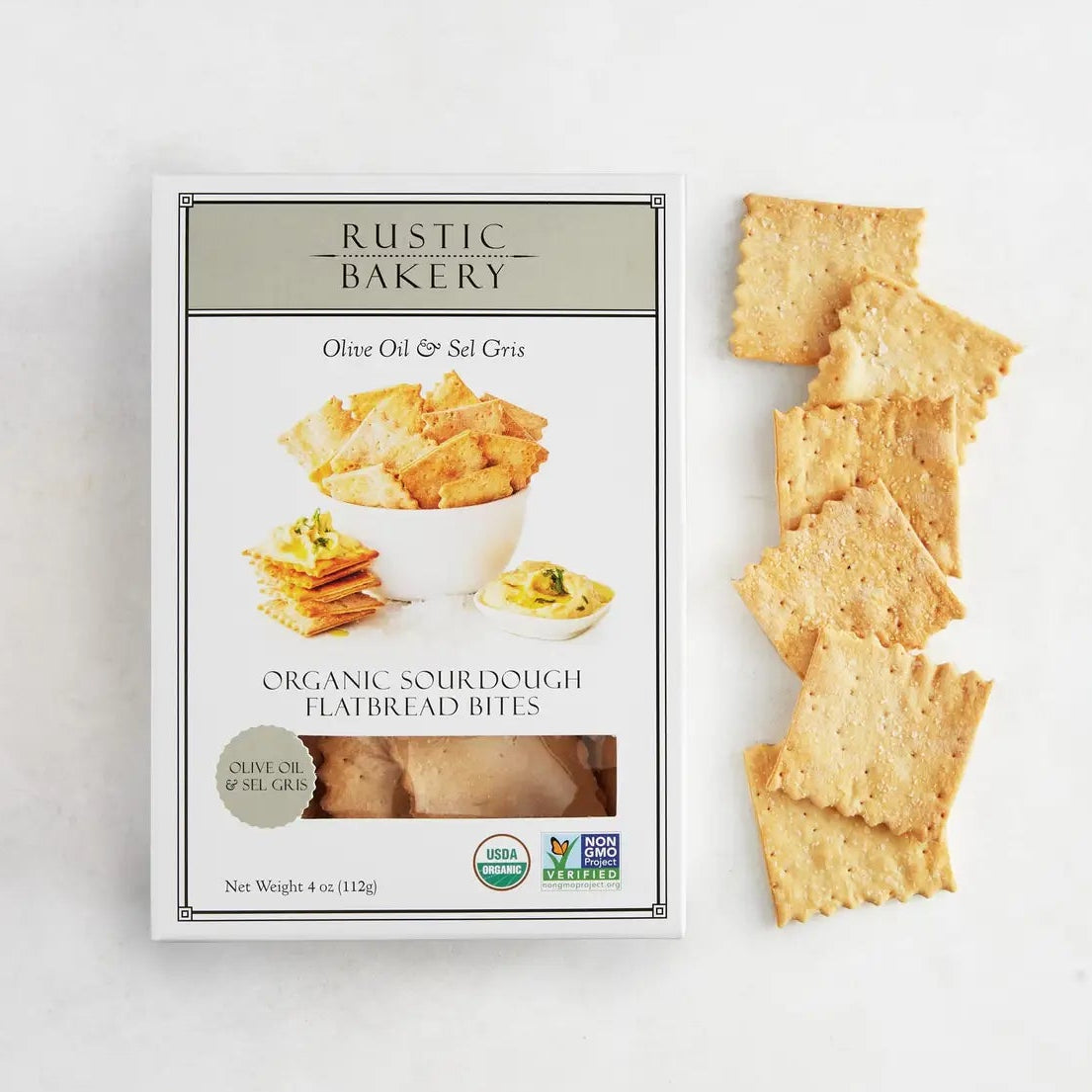 Box of Rustic Bakery organic sourdough flatbread bites with crackers on a white background