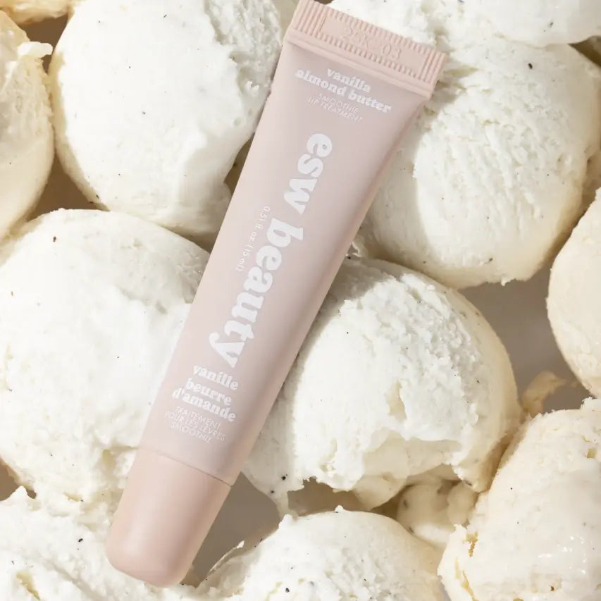Pink tube of Easy Bama bath butter surrounded by white bath bombs.