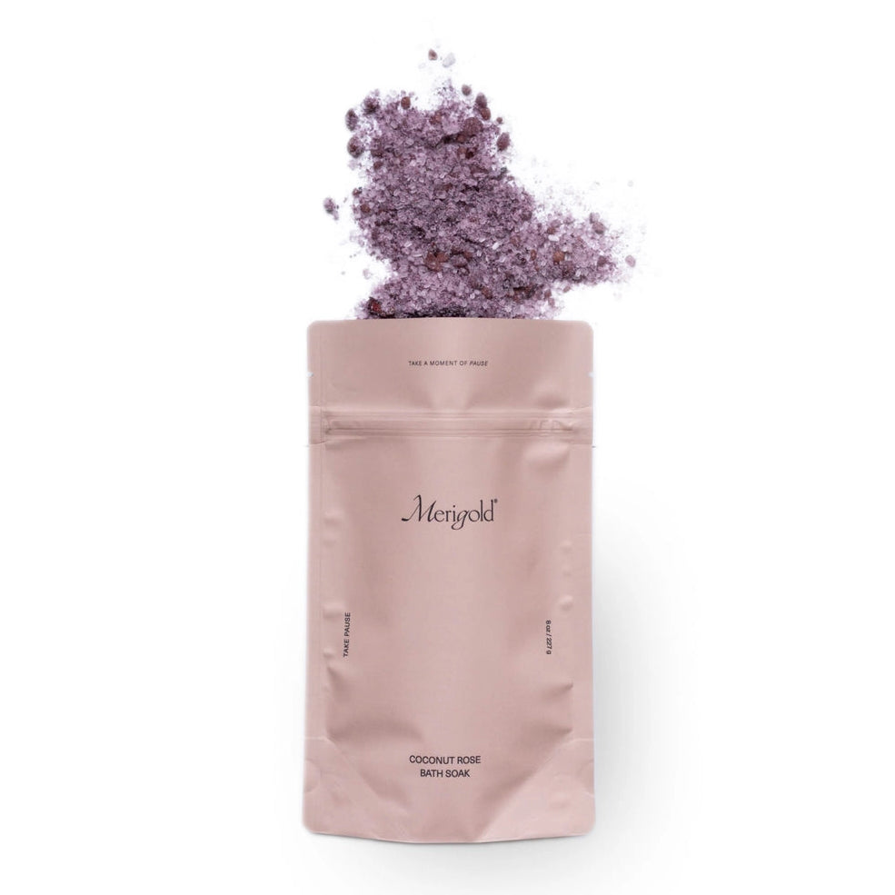 Pink packaging of Menopold with purple flowers on a white background