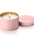 A pink metal candle tin with a lit wick and white wax, shown next to its matching pink lid on a clean white background. The lid features the brand name 'MAYIHEKE' embossed on top.