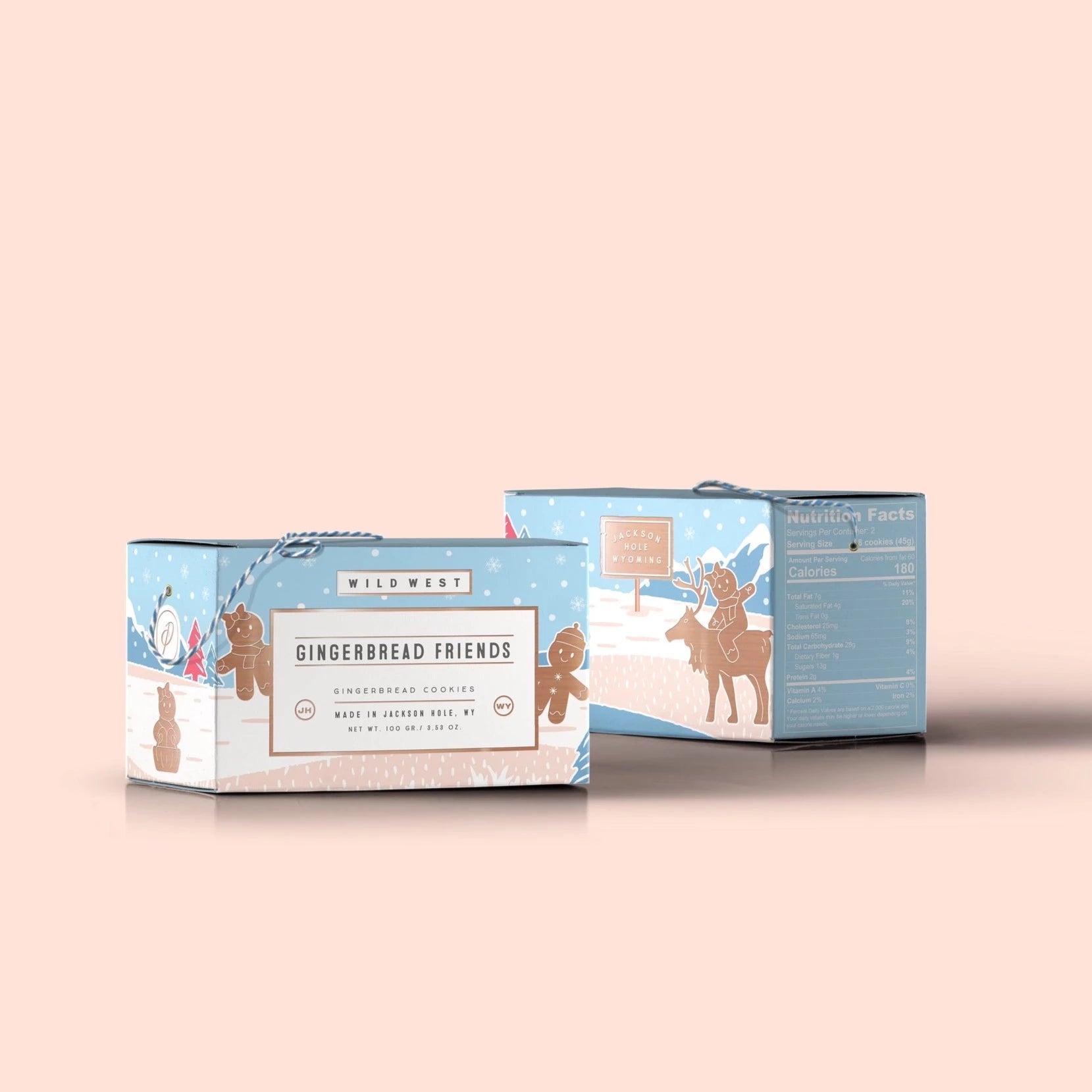 Pastel blue and pink box with gingerbread figures illustrated on it. Box has blue and white string at the top to carry the box. Box has text on the from and side panel.