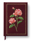 maroon fabric journal with pink roses embroidered on it