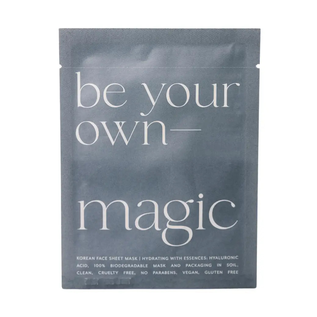 A single-use skincare packet for a Korean face sheet mask. The packaging is a dark slate gray with white text reading 'be your own-magic' and smaller text detailing the hydrating ingredients and product features.