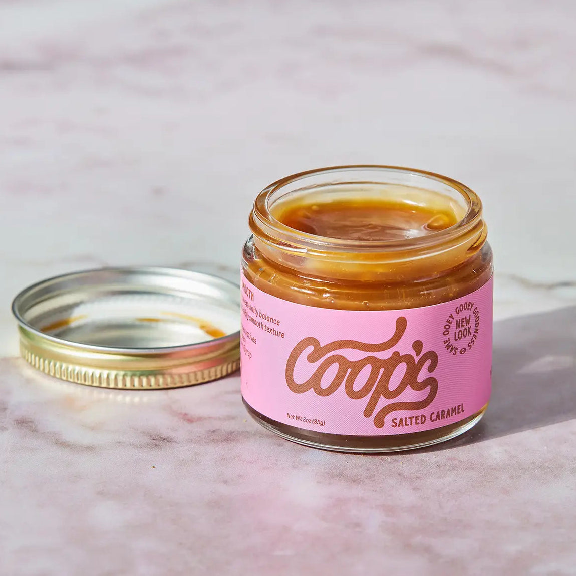 Jar of Coop's salted caramel on a marble surface