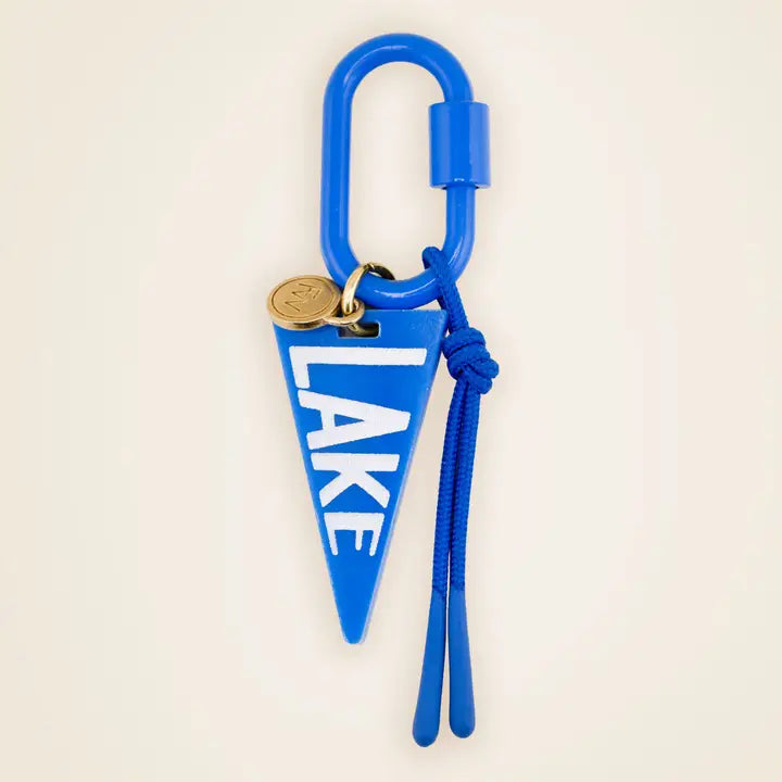 blue lake bag charm on a beige background