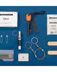 Collection of emergency survival items including a fire starter, personal wipes, and band-aids on a blue background.