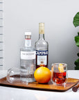 Clear Stemless Glasses (Set of 2) on tray with orange, gin and campari