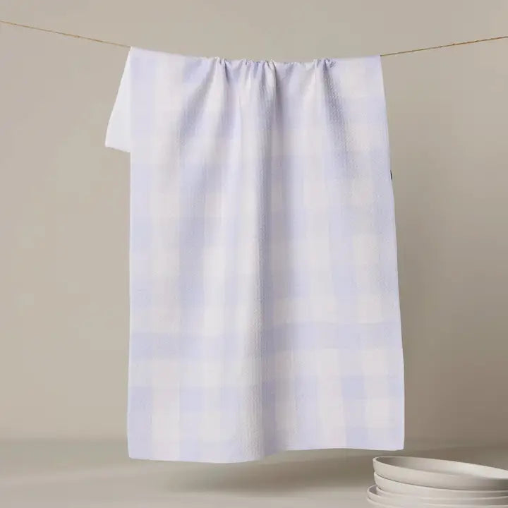 White towel hanging on a line with a neutral background