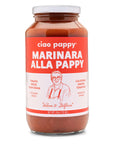 clear glass bottle with marinara sauce in it. bottle has white & red label