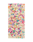 Chocolate bar with colorful sprinkles on a white background
