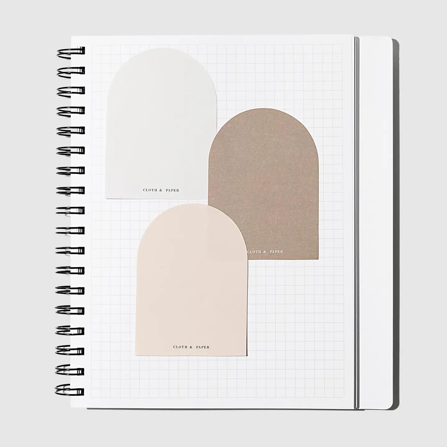 Notebook with geometric arch designs on a white background