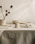 Oyster mug on table with dishware items in background