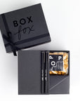 BOXFOX Black Matte Gift box with Appointed Co Linen Jotter Notebook, paid of 2 black Le Pens, Art of Caramel Poprcorn and Areaware Black Playing cards