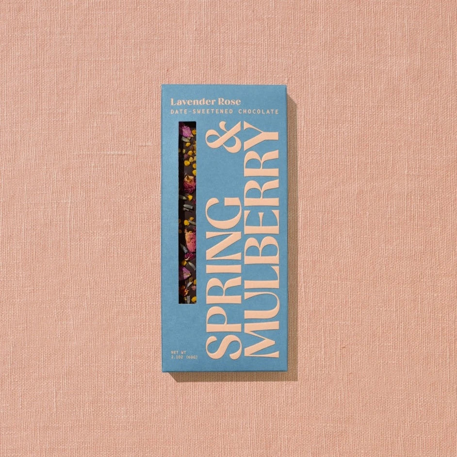 A rectangular chocolate bar packaged in sky blue paper with beige text reading &quot;Lavender Rose&quot;