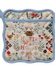 Quilted pot holder with 'Home Sweet Home' text and floral patterns on a white background
