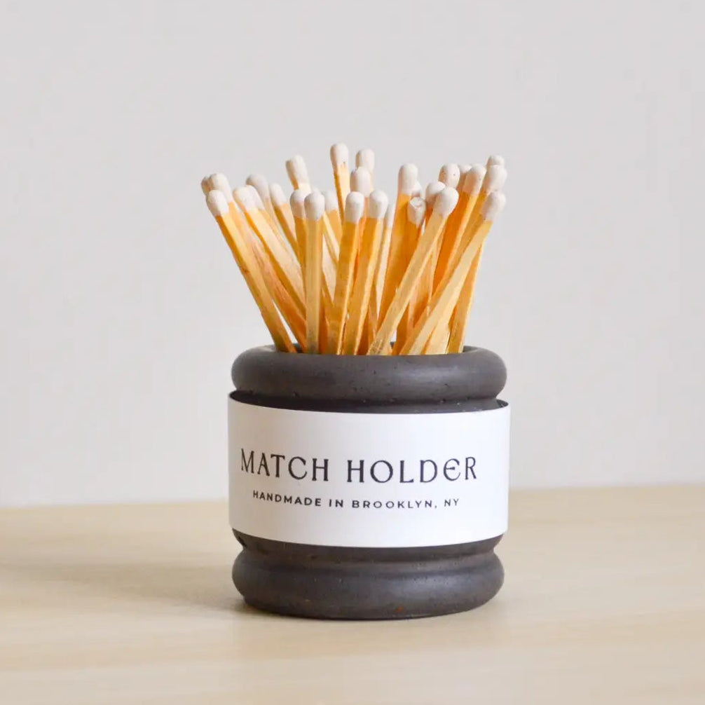 Match holder with matches on a light background
