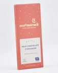 Close up of moonstruck orange milk chocolate cinnamon bar on a white background
