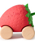 Strawberry-shaped toy with wooden wheels on a white background