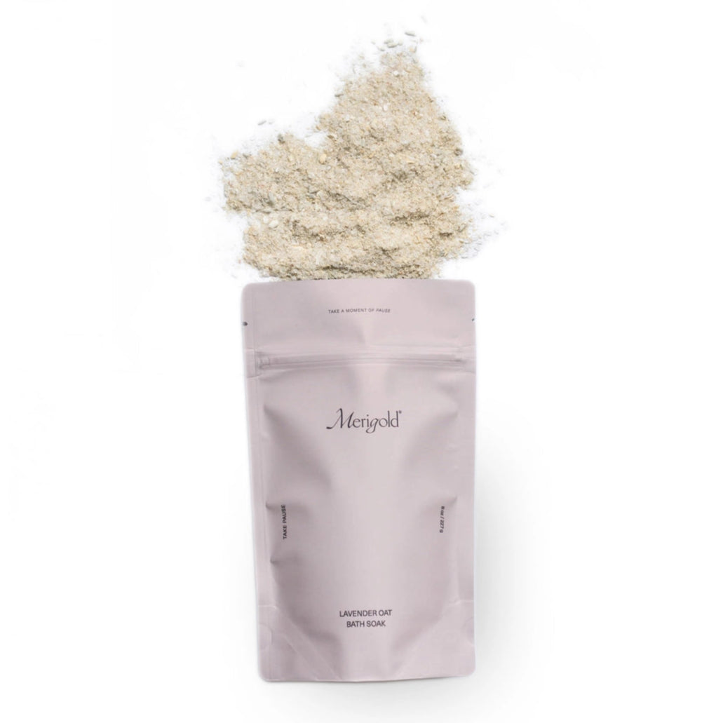Purple package of Merigold bath salts with a heaped amount of white powder on a white background