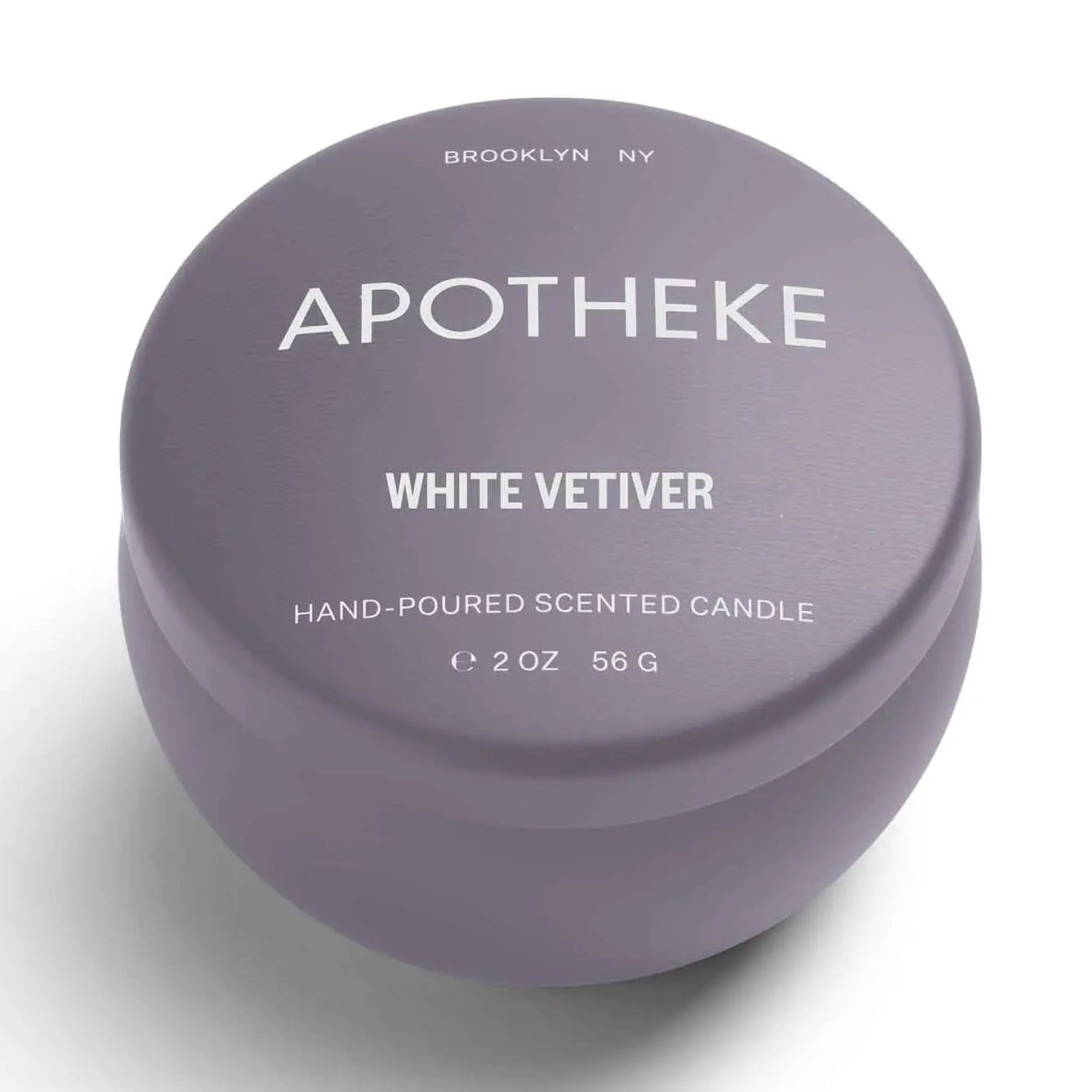 Purple mini tin candle that has white vetiver written on it in white