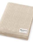 Beige ribbed blanket with Bleu-La-La label on a white background