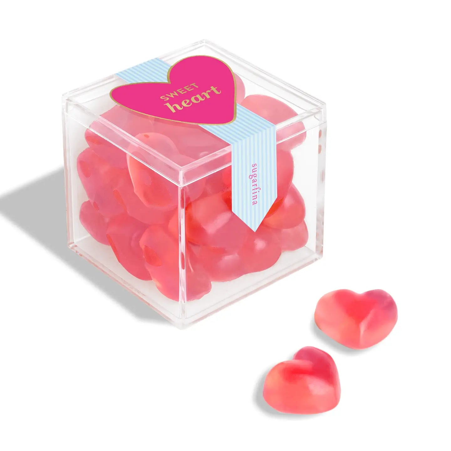 Clear cube box filled with pink heart-shaped candies on a white background