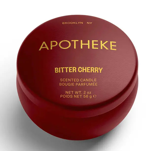 Red container of Apotheke Bitter Cherry scented candle on a white background