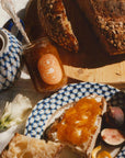 orange marmalade jar with orange label on breakfast table