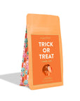 Orange bag of 'Trick or Treat' candy mix from sugarfina on a white background