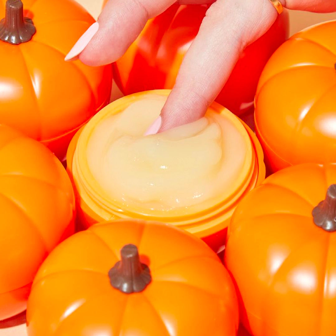 finger dipping into pumpkin shaped eye cream