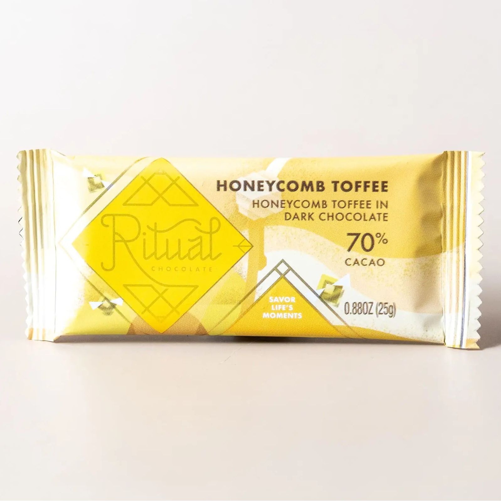 Chocolate bar with honeycomb toffee flavor packaging on a light gray background
