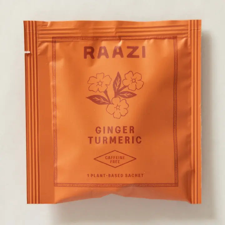 Orange package of RAAZI Ginger Turmeric on a light gray background