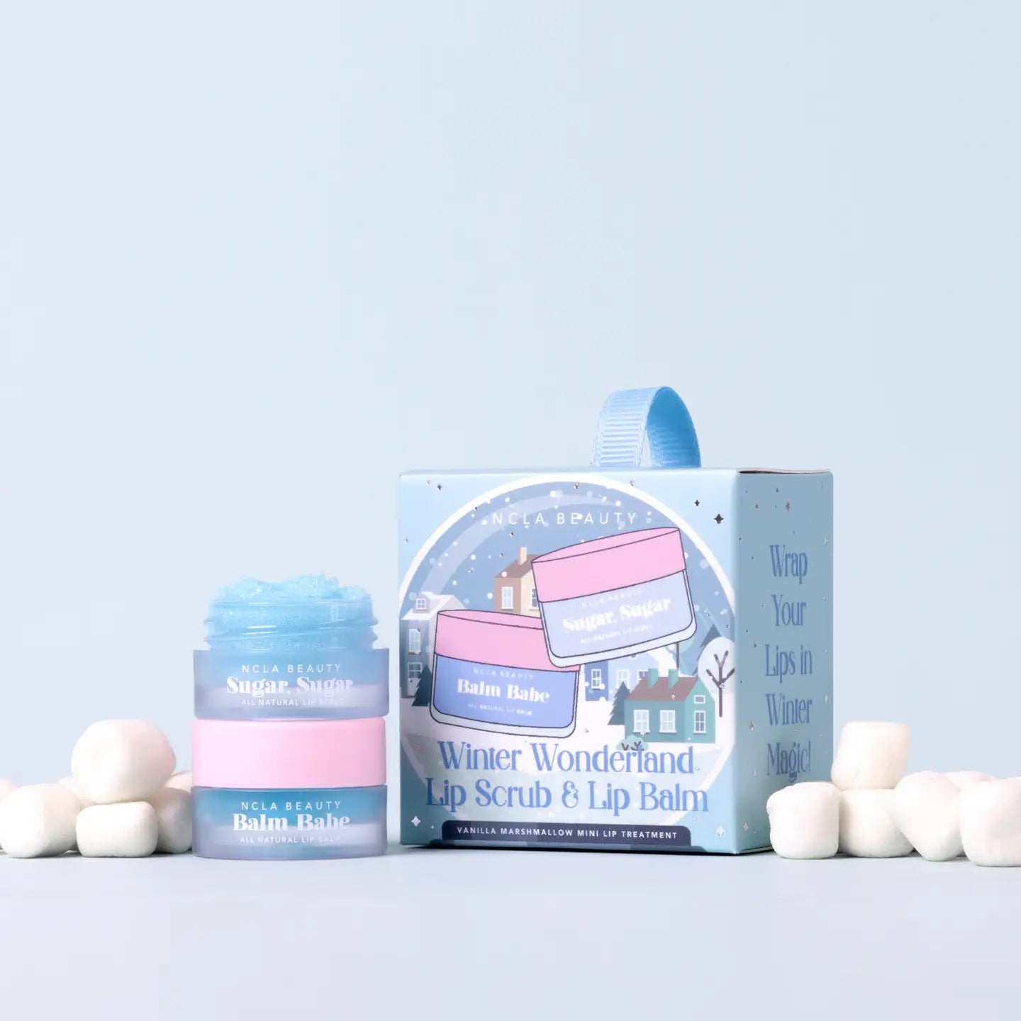 Wila Beauty lip scrub and lip balm set with packaging on a light blue background