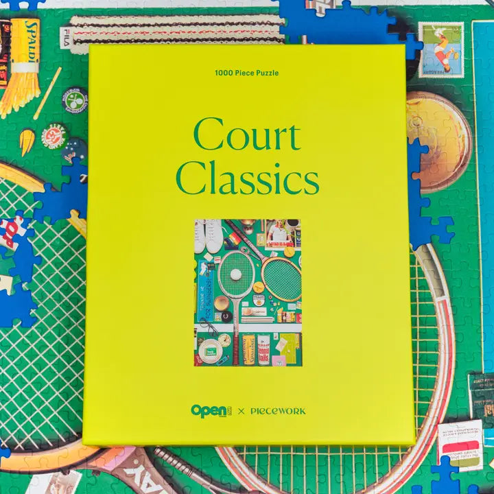 Green puzzle box labeled 'Court Classics' with a colorful illustration on a partially completed puzzle.