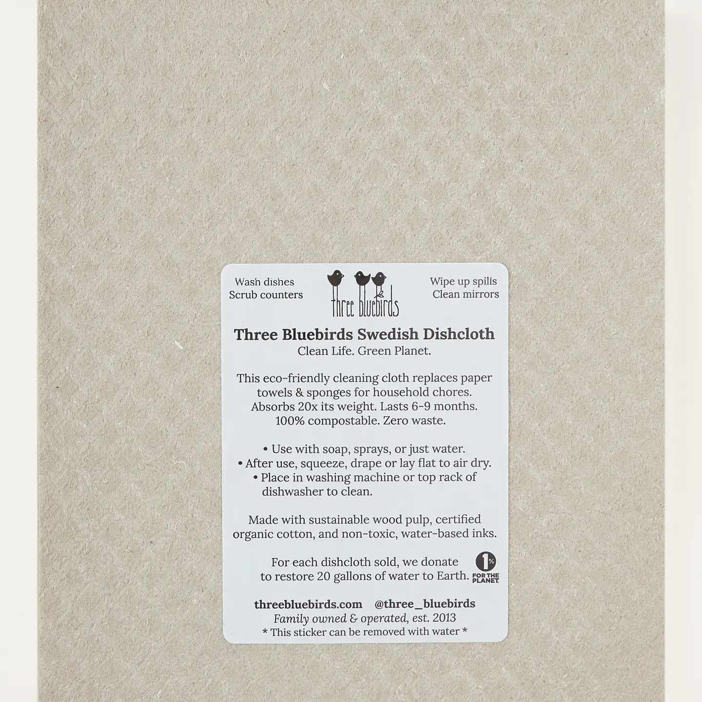 A pack of Three Bluebirds Swedish Dishcloth paper towels wrapped in a clear plastic sleeve with a white product information label on the front.