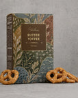 Butter toffee pretzels on a grey background
