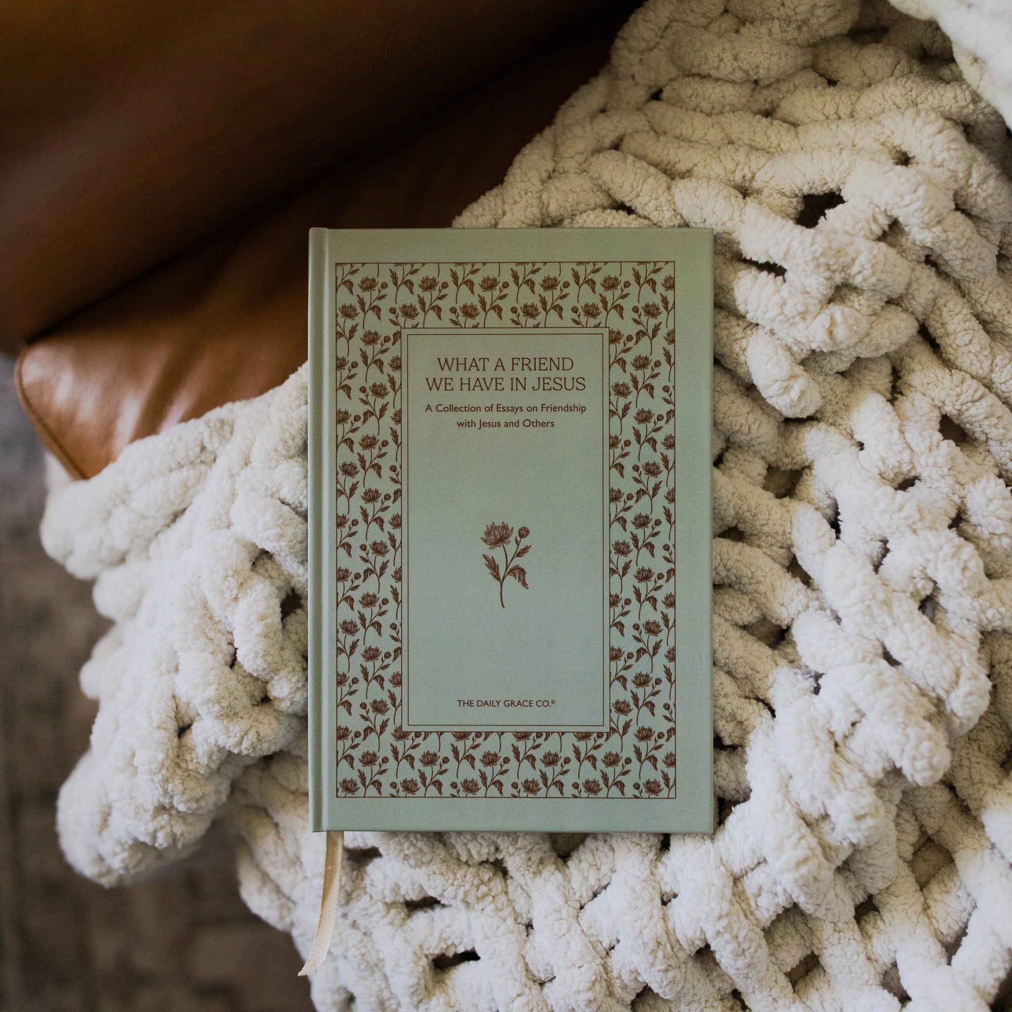 Book titled 'What a Friend We Have in Jesus' on a textured surface