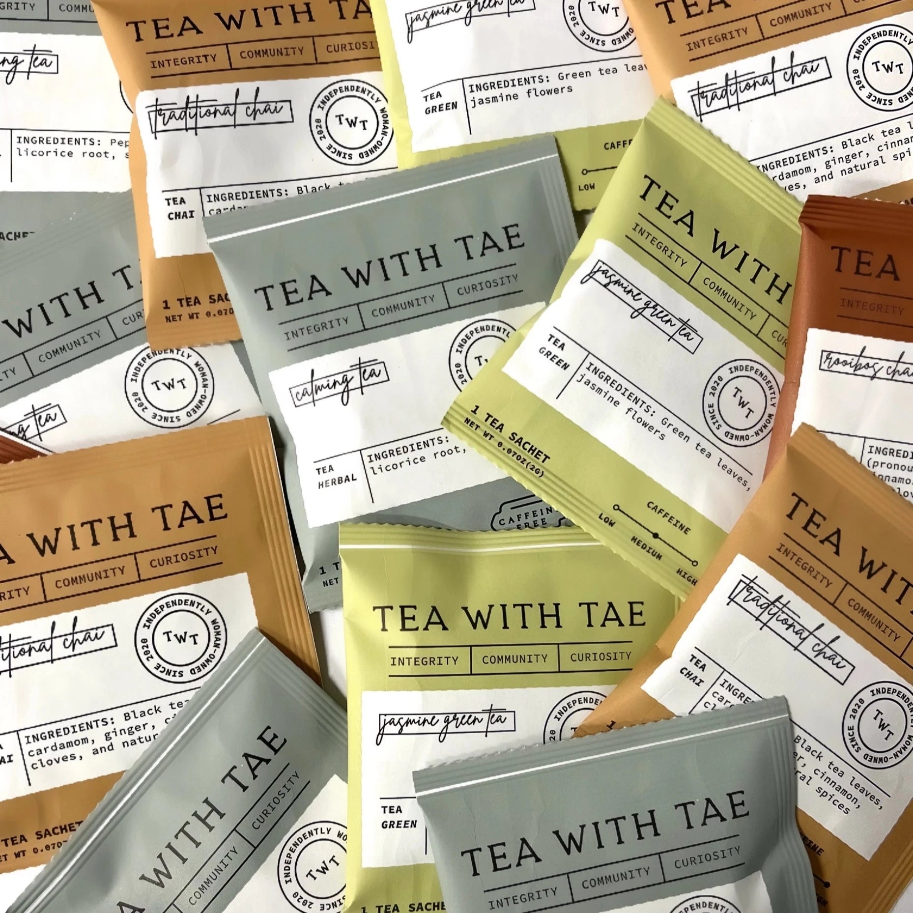 pile of tea sachets all together, green, brown and dark brown as well as pale blue. calming tea is front and center among the pile. 