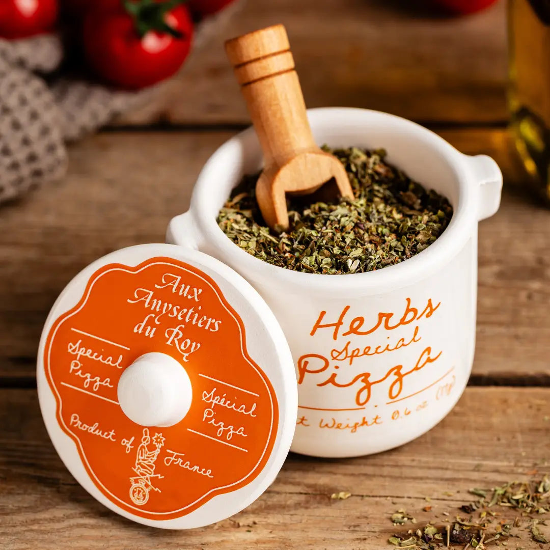 Herb container with wooden scoop on a wooden surface, featuring 'Herbs Special Pizza' branding.