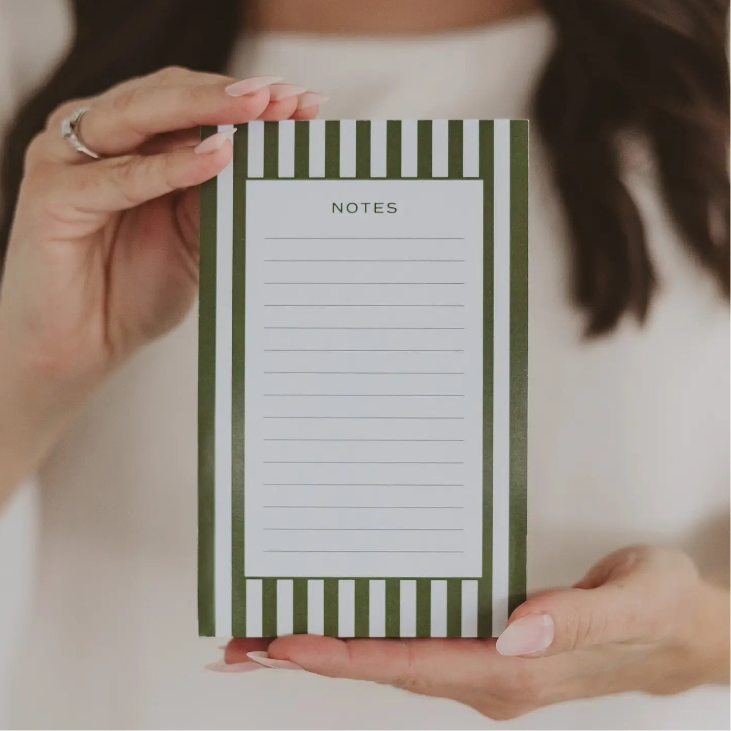 white and green striped notepad 