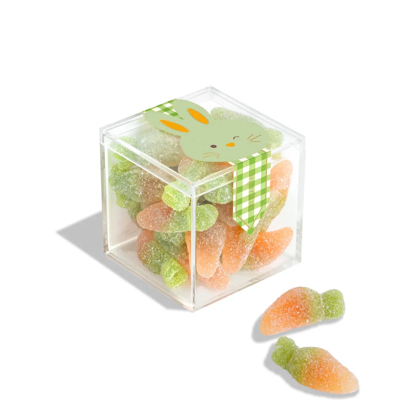 Clear cube container filled with gummy candies shaped like carrots and turtles, with a green bunny on top.