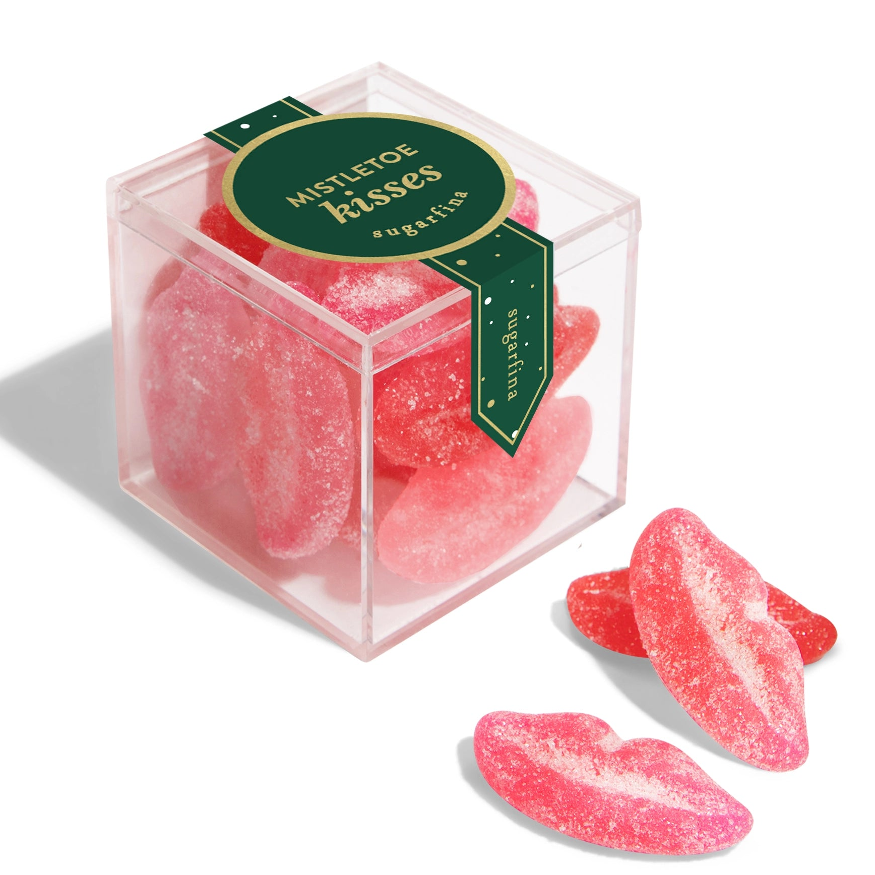 Pink candy shaped like lips in a clear box with a green label on a white background