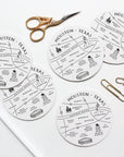 Houston, Texas-themed coasters with cut-out designs on a white surface with scissors and paper clips.