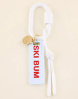 Keychain with 'SKI BUM' tag on a beige background