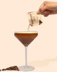 Espresso martini glass with hand pouring mix into it