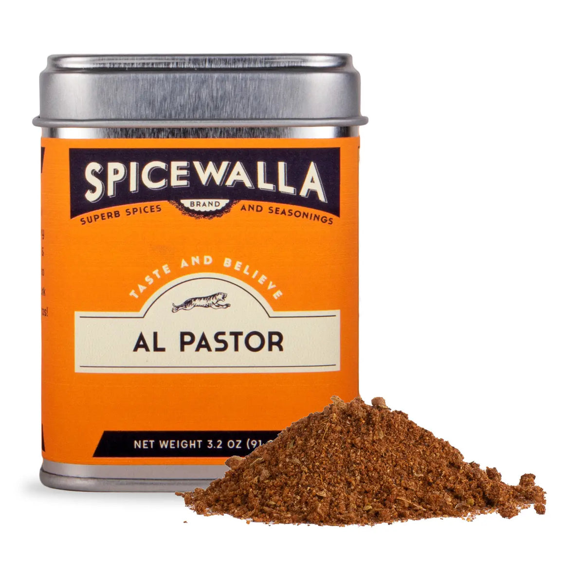 A tin of Spicewalla Al Pastor seasoning with a pile of the brown spice blend in front, on a white background.