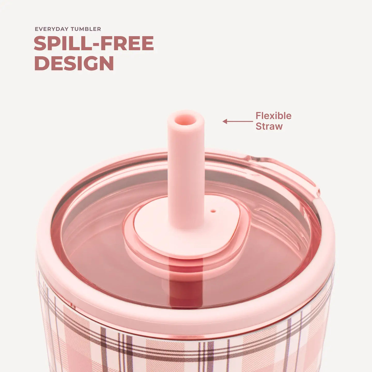 Close-up of a pink tumbler with a flexible straw lid, featuring a plaid pattern and text overlays highlighting spill-free design.