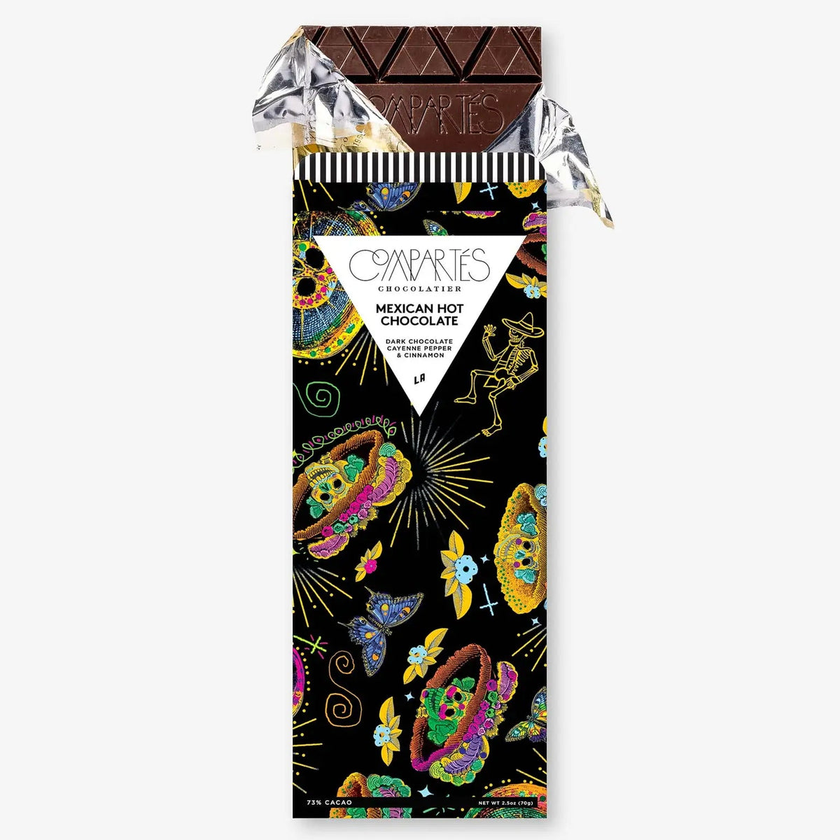 A wrapped chocolate bar from Companys Confectionery, featuring a black wrapper decorated with colorful Mexican hot chocolate motifs like sugar skulls, butterflies, and skeletons, with a partially unwrapped dark chocolate bar at the top.