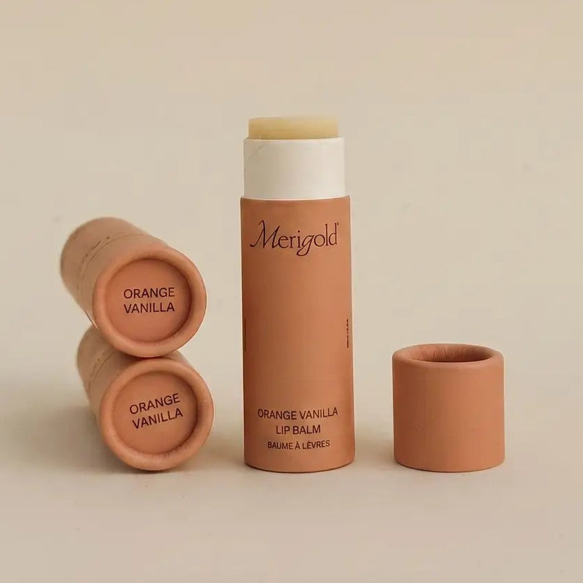 orange merigold lip balms on a beige background 