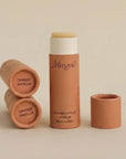 orange merigold lip balms on a beige background 